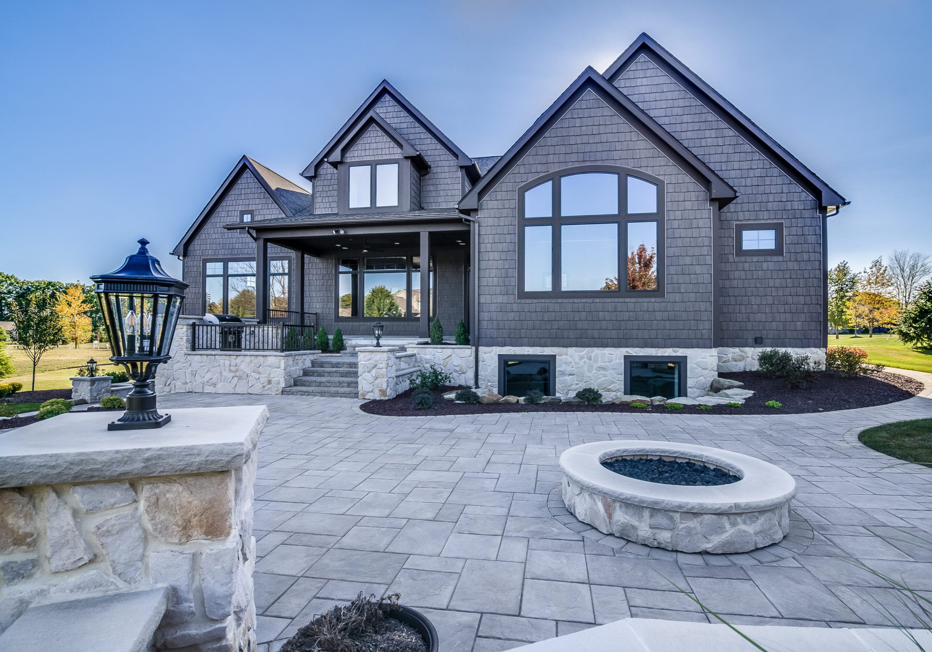 Stone and concrete back patio area with lots of entertaining options