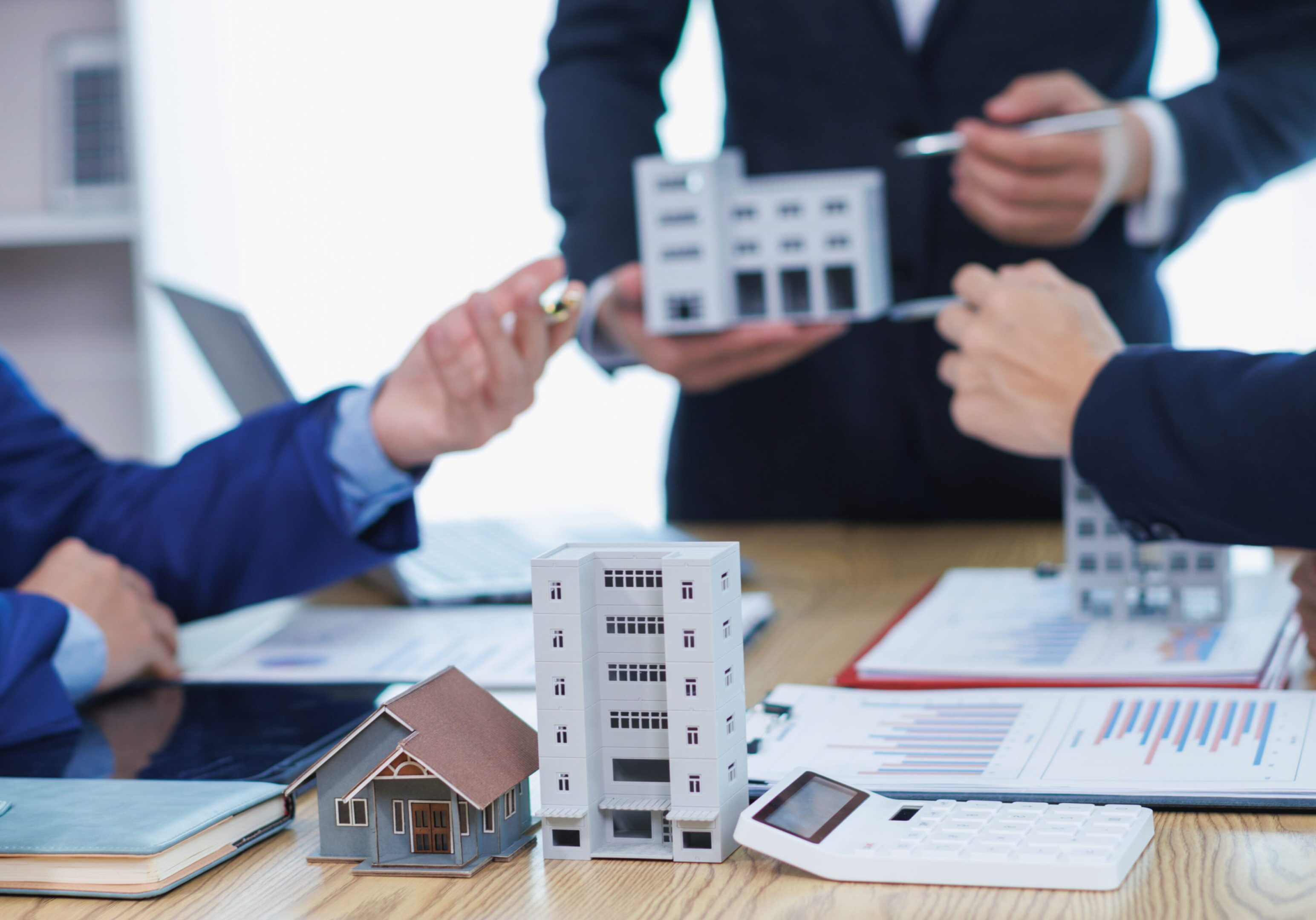 Real estate meeting with model buildings.